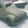 Sculpture of a wrecked VW Beetle.