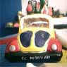 A Mexican naif VW Beetle sculpture with many details.