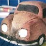 This is a 'naif' VW Beetle carved out of a coconut!